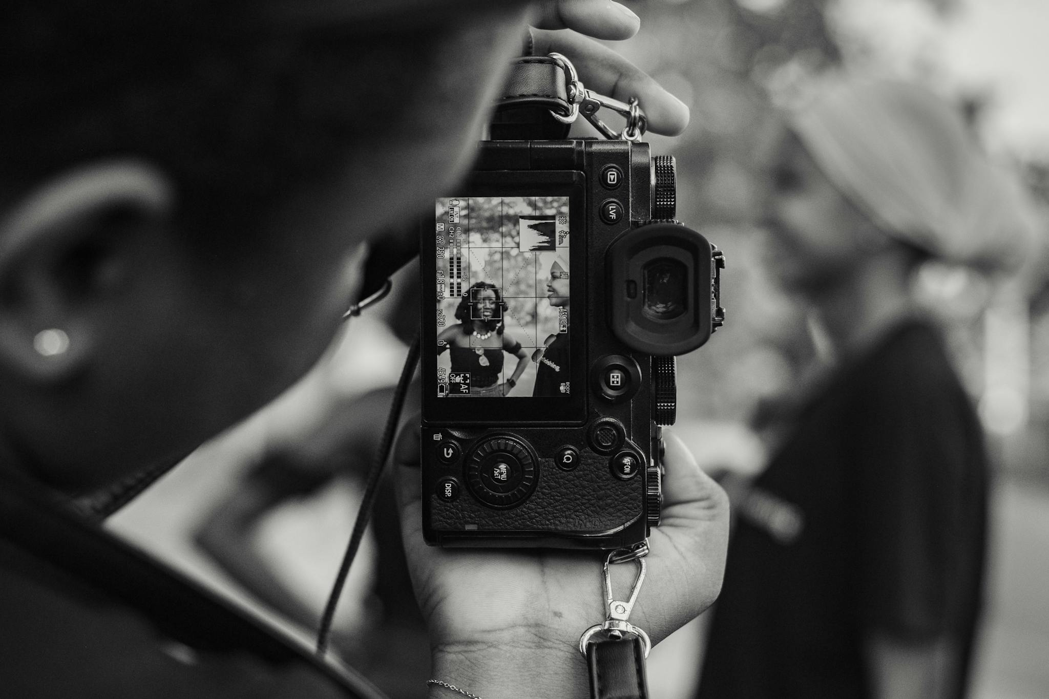 Black and white photo capturing a candid moment through a camera in Accra, Ghana.